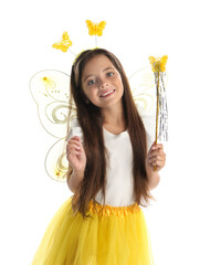 Cute little girl in fairy costume with yellow wings and magic wand on white background