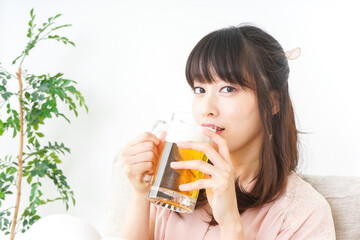 自宅でビールを飲む若い女性