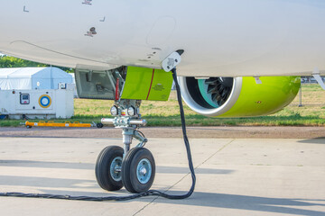 Ground power unit GPU supplying power to parked aircraft.