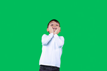 The boy holding his face with the hands looking up emotionally with facial expression looking up. 