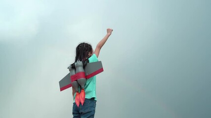 Side view of child girl playing outdoors with a toy rocket, Kid flying to the sky with a rocket jetpack like a superhero pilot. - Powered by Adobe