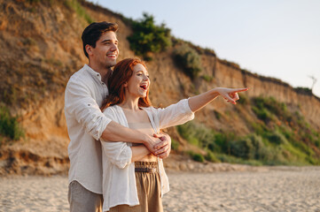 Profile happy smiling young couple two friends family man woman in white clothes hug rest relax...