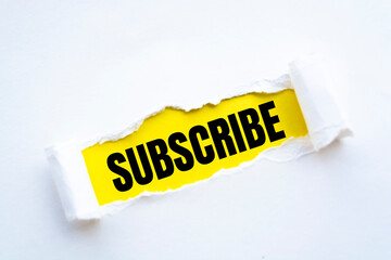 The word subscribe appearing behind torn paper
