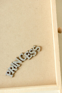 the word "princess" in glittery silver letters on the bottom of a small drawer background