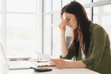 Fototapeta Young tired stressed overworked businesswoman freelancer teacher student exhausted after hard work, suffering from migraine headache at office. Deadline, fired worker, debt, problems concept obraz