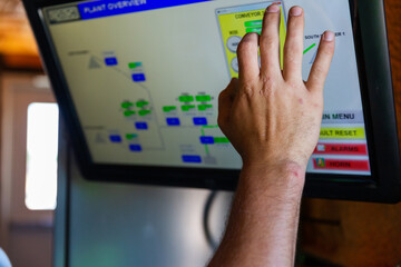 A technician makes an adjustment on a touch screen