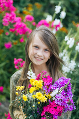 Naklejka premium beautiful attractive stylish girl in green dress holding flower, romantic mood, posing in summer fashion style, natural look