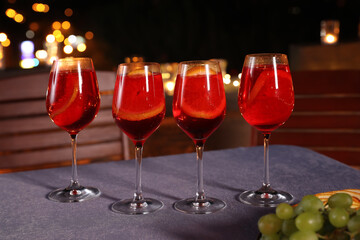 Glasses of cocktails on table in cafe with outdoor terrace