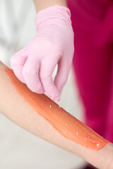 master of depilation in the hands of wax polymer sugaring