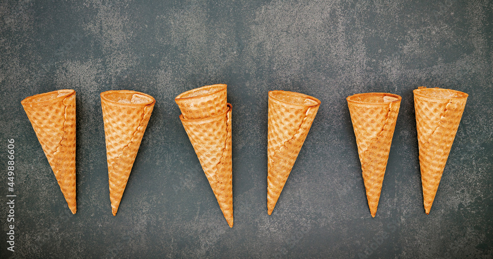 Poster flat lay ice cream cones collection on dark stone background . blank crispy ice cream cone with copy