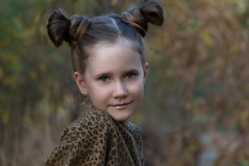 portrait of a little girl in autumn park