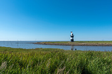 Fototapeta premium Coastal Landscape with the lighthouse Little Prussian near Wremen