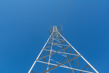 Electrical line tower on blue sky background.