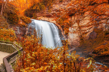 Looking Glass Falls in Pisgah National Forest, North Carolina, USA with early autumn foliage. - obrazy, fototapety, plakaty