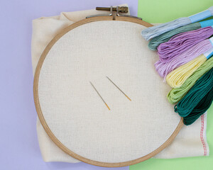 The counting fabric is stretched over the wooden hoop before embroidering.