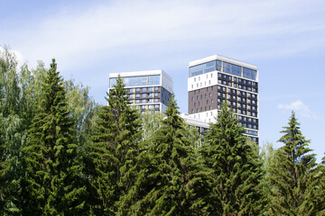 Residential multi-storey buildings peek out from the trees.