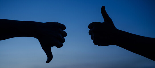 Thumb up and thumb down hand. Two hands showing different gestures. Yes or no silhouette. Like and...