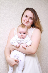 home photos of a young mother with a small child. Newborn boy. Cute, cozy photos with a baby.