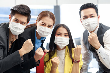 Group of young Asian business team with the mask on working together in the office. Office business people brainstorming in the meeting. Strat up business team discussing about new project