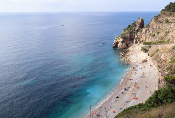 Mediterranean hidden beach surrounded by cliffs in Alicante, Spain