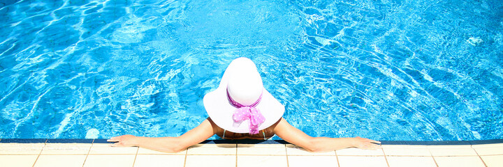 girl with a hat in waterpool