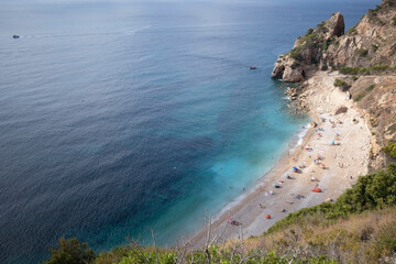 Mediterranean hidden beach surrounded by cliffs in Alicante, Spain