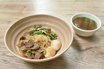 boiled dry vermicelli thin rice noodles topping slice braised pork and meatball dressing sweet black soybean sauce on bowl