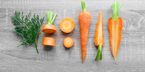Different cuts of carrot on wooden background, cooking concept