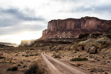A two track dirt road heading into the sunset of Canyonlands National Park