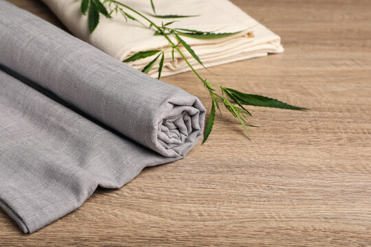 Hemp cloths and green branch on wooden table
