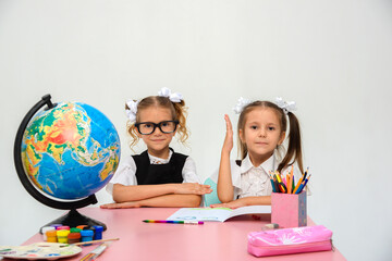 two schoolgirls doing homework. study, write, paint on a white background. isolate