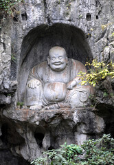 Fototapeta na wymiar Hangzhou, Zhejiang Province, China: Lingyin Temple also known as the Temple of the Soul's Retreat in Hangzhou, China. Buddha carving at Feilai Feng a limestone peak near to the front of the temple.