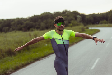 Image of young professional male triathlete, runner outdoors on open road. Concept of sport,...