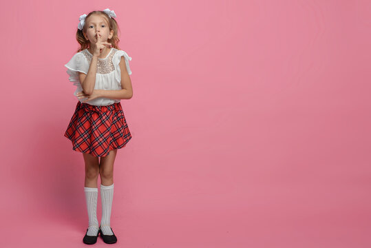 portrait of a cute schoolgirl with different emotions Isolated on pink background