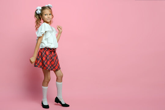 portrait of a cute schoolgirl with different emotions Isolated on pink background