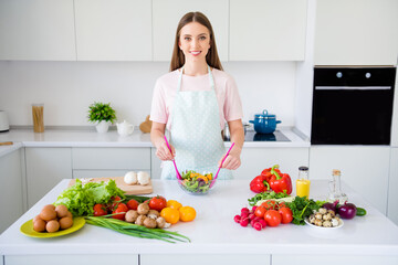 Portrait of attractive cheerful girl making fresh meal organic bio product tasty yummy salad at home light white kitchen indoors