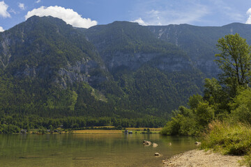 Fototapeta na wymiar Alpine lake surrounded by Austrian Alps mountains in summer sunny day