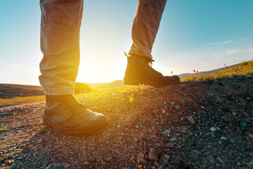 Hiking boot on rocky mountain terrain, man walking outdoor in nature