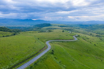 Fototapeta premium Above view of countryside road, aerial view