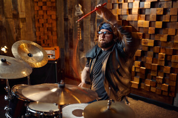 Brutal drummer behind the drum kit on stage