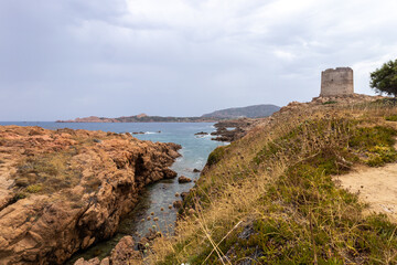 beautiful beach and characteristic reddish rocks of Isola Rossa and Aragonese Tower,  Paradiso....
