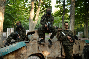 Paintball team, friends poses on playground