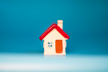 Fototapeta na wymiar Closeup miniature house on blue background using as property real estate and family concept