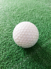 White golf ball on grass.