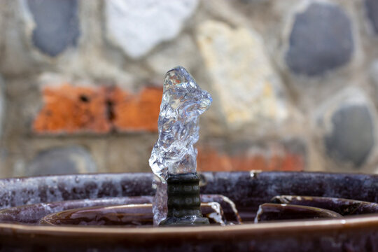 Drink Water Fountain Outdoor In A Park. Water Streaming From Metallic Drinking Fountain. Old Beautiful Stone Wall On Background. Nobody. No People. Concept Image.