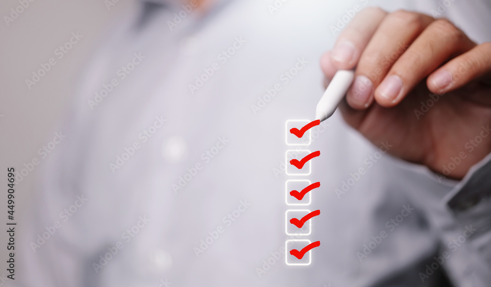 Poster Checklist concept, Businessman checking mark on the check boxes with marker red
