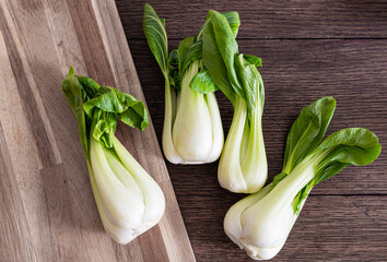 top view of fresh Bok Choy, chinese cabbage, on rustic wooden table