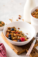 Homemade granola with milk honey nuts and fresh berries