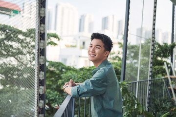 teenager smiling on the terrace - obrazy, fototapety, plakaty