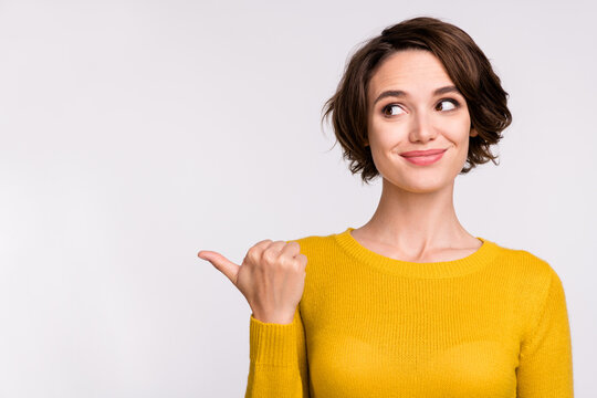 Photo Of Young Girl Happy Positive Smile Point Thumb Empty Space Ad Advice Choose Isolated Over Grey Color Background